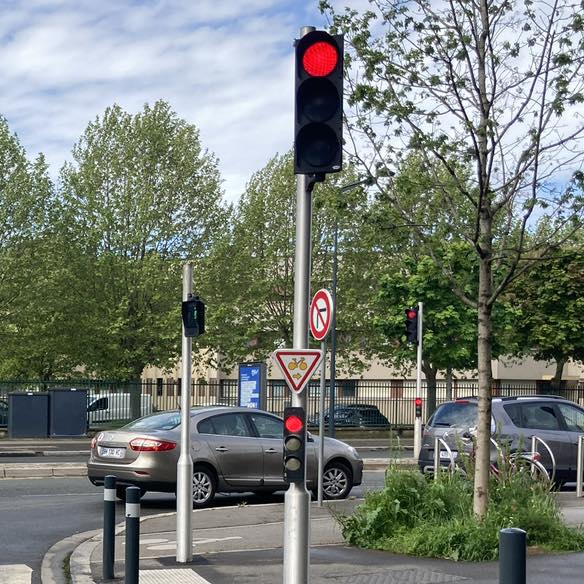 Un panneau permettant à celles et ceux qui se déplacent à vélo à Maisons-Alfort de franchir le feu rouge, en cédant la priorité aux autres usagers.